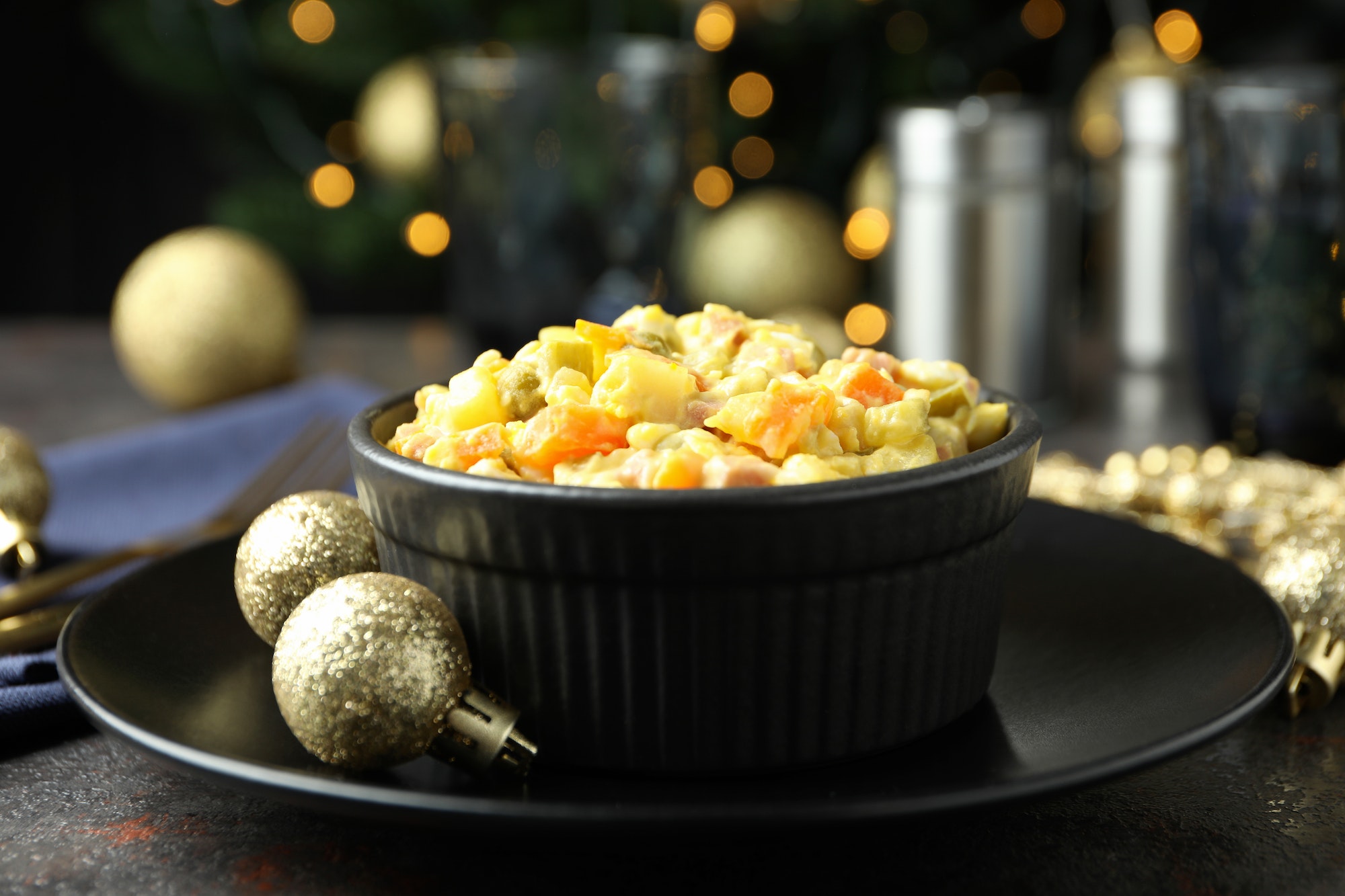 Christmas concept of tasty food with Olivier salad and bokeh