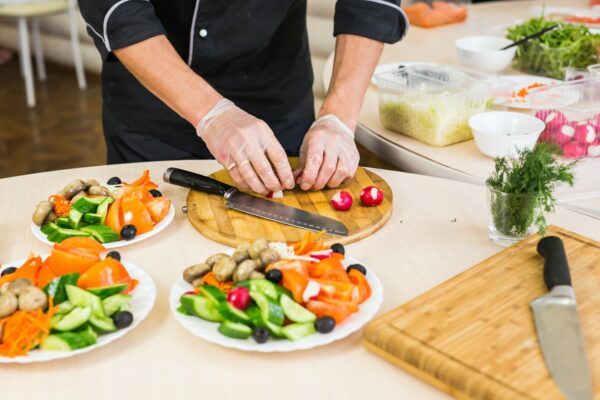 Close-up of chef cooking food kitchen restaurant cutting cook hands hotel man male knife preparation