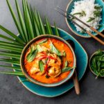 THAI SHRIMPS RED CURRY. Thailand Thai tradition red curry soup with shrimps prawns and coconut milk